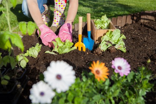 Volunteer assisting a visitor with mobility-friendly gardening tools